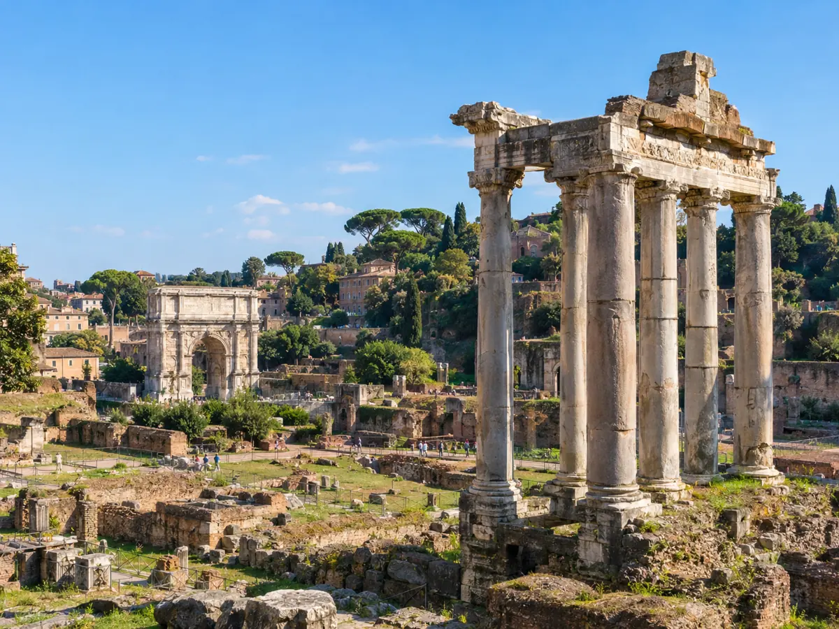 Corinthian columns of a temple in the Roman Forum with ruins and pines beyond