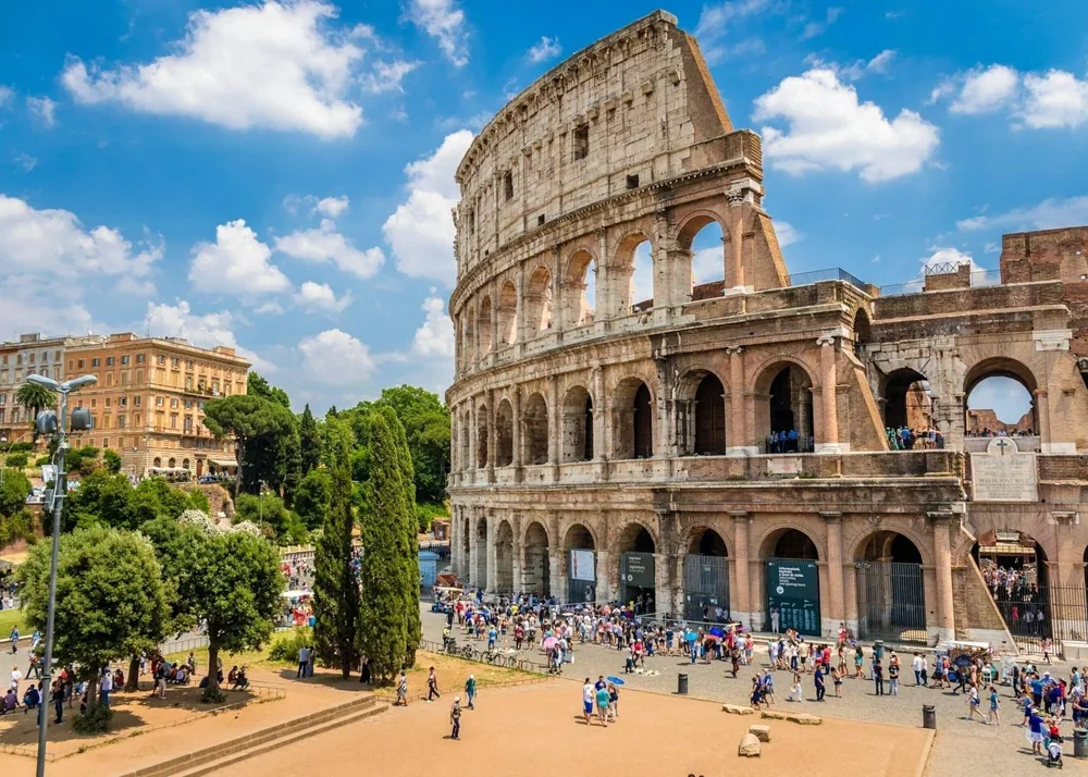 Crowds of visitors outside the arches of the Colosseum