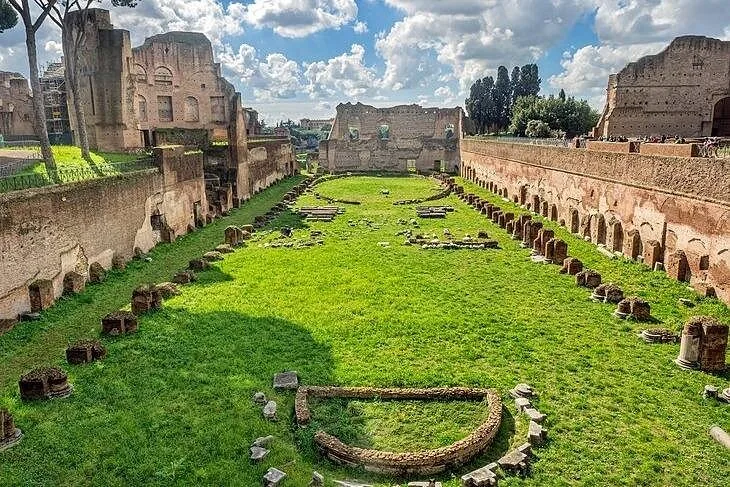 The long lawn of the Palatine Stadium among brick ruins